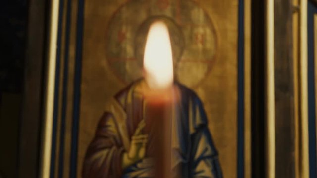 Icon of Jesus Christ and burning candles 
in an Orthodox Church. 
Eastern Europe, cca. 2017