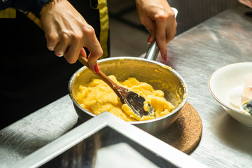 kneading dough manually in a metal pan at home