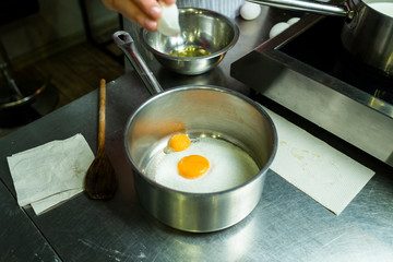 adding chicken eggs to cream for cooking