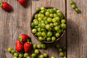 strawberries and gooseberries in the garden on the table