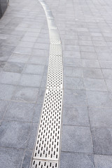 Gutter cover or sewer drain on roadside. street rain gutter