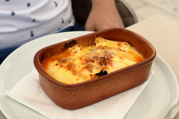Lasagne baked in a ceramic bowl