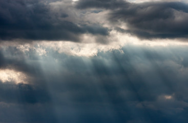 Fototapeta premium Dramatic dark and light cloudy sky with rays of sunlight