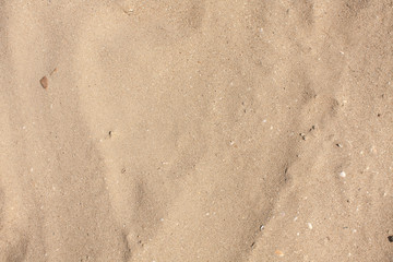 Fototapeta na wymiar Sandy beach pattern closeup, Summer seacoast background.