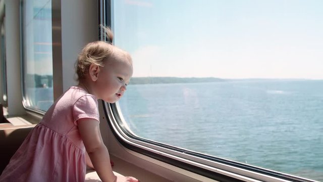 Cute Baby Girl Looking Out Ferry Window