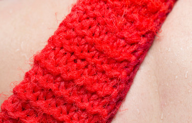 A person bathes in the shower with a washcloth