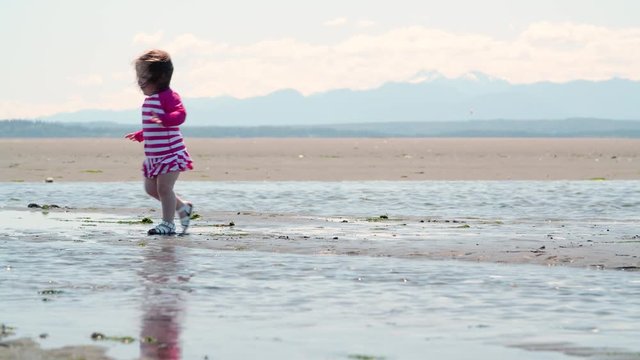 Little Girl Walking on Pacific Northwest Sandy Ocean Beach