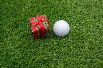 Merry Christmas to golfer with Christmas ornament on green grass
