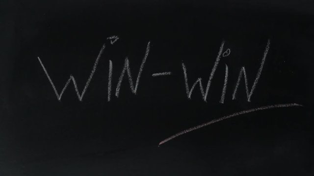 Hand underlines the word win a on chalkboard . Win win strategy concept