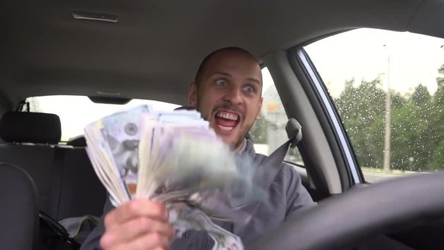 Happy driver with big money dollars. Success. Concept on the topic of lottery, winnings, slot machines, business success.