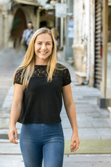 A poland blonde young woman, 24 years, walking looking camera, smiling, outdoors.