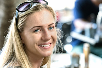 A poland young woman, 24 years, looking camera with sunglasses on forehead, smiling, outdoors.