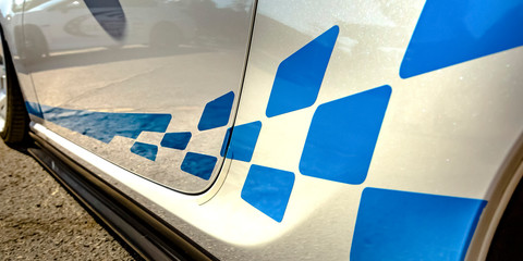 Blue decal on the exterior body of a white car