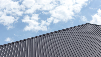 Fototapeta na wymiar Roof of a house on a blue sky background