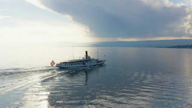 Following and closing-in on Belle-Epoque steam boat on Lake L&radic;&copy;man - Switzerland
Sunset, mirror-like water and storm-clouds in the background