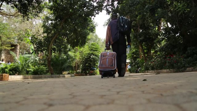 a traveler walking pulling briefcase long journey starts with a step to your destination