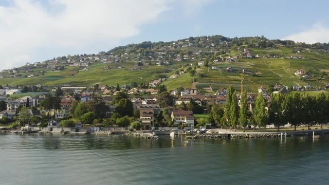 Aerial orbit over Lake L&radic;&copy;man in front of Cully, Lavaux - Switzerland. Kayak entering small port