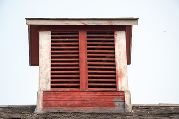 Fototapeta na wymiar Old red barn with rustic weathered cupola