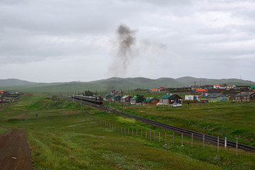 Fototapeta na wymiar 雨のモンゴルを走る旅客列車