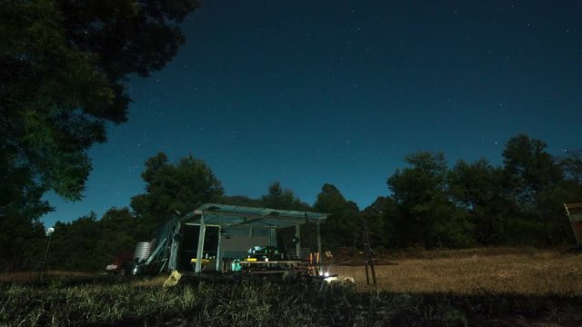 Farmshed at night with stars in the sky time-lapse with shooting star