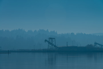 Industrial part of Coos Bay Oregon logging industry during hazy morning