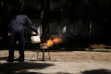 Firefighters in show the heat of a flame and the use of fire extinguishers.