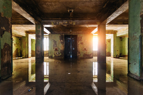 Dark rotten ruined flooded by rains abandoned building