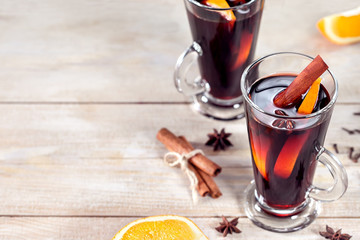 Mulled wine with cinnamon sticks and orange. Top view with copy space.
