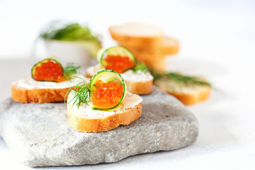 Sandwich with ricotta, a cucumber, caviar .
