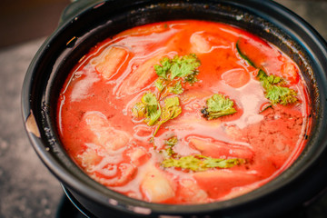 Tom Yum Thai style hot and sour soup with sea bass, squid and prawns