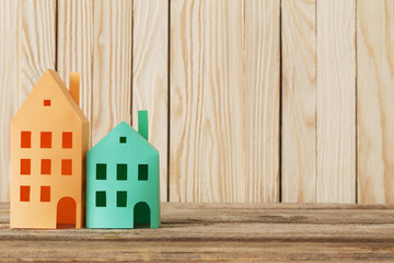 paper houses on wooden background