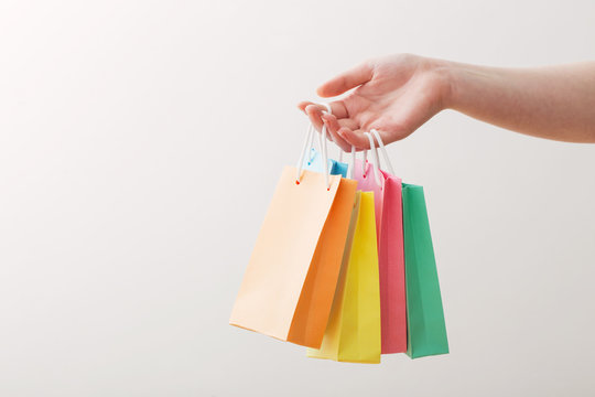 womens hand with paper bag isolated on white