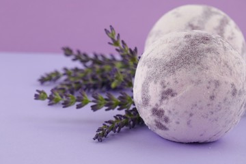 lavender bath bomb.Organic body cosmetics with lavender extract. purple bath bombs and sprigs of...