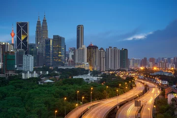 Gordijnen Kuala Lumpur night cityscape skyline with illuminated highway flyover road © jamesteohart