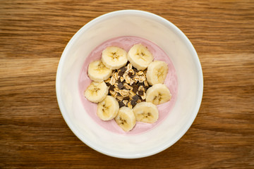 bowl of cereal with yoghurt and bananas