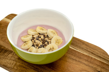 bowl of cereal with yoghurt and bananas