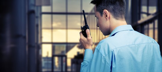 Young man in blue shirt using radio
