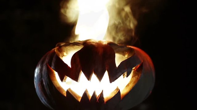 Burning smile pumpkin on Halloween. Looped