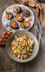 Salad with mussels and sweet peppers, canapes with tomatoes. Mediterranean Kitchen