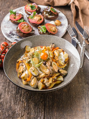 Salad with mussels and sweet peppers, canapes with tomatoes. Mediterranean Kitchen