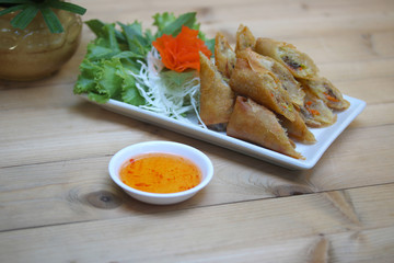 Fried Chinese Traditional Spring rolls food on white dish..