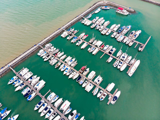Fototapeta na wymiar Bird's-eye view, Boats and Yacht parking / modern water transport with mooring facility - luxury lifestyle, wealth concept