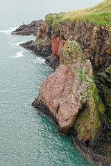 Fisherman at shoreline of North Sea near Long Slough, Aberdeenshire, Scotland