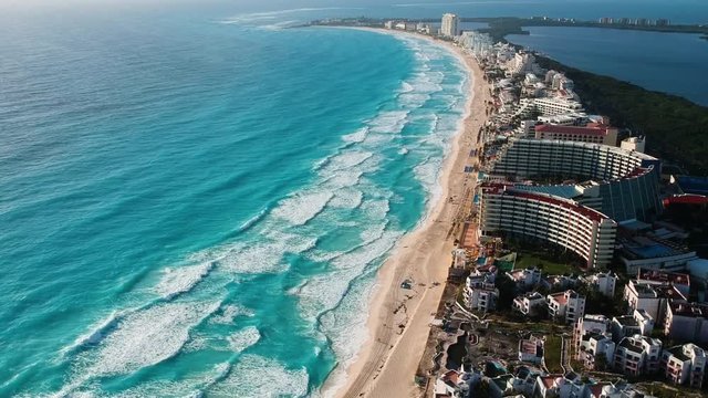 Aerial view of Cancun caribbean sea, the drone is flying upward seeing the blue ocean horizon
