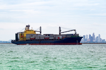Aerial view of Small container ship at sea freight, Business International trade and Container logistics export-import harbor to the International port / Shipping Containers concept.