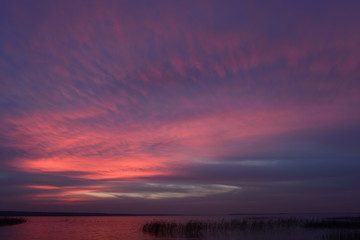 Glow sky twilight bright colors after sunset nightfall on the lake autumn