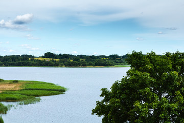 Fototapeta na wymiar Ludza lake in the end of June, cloudy weather in summer