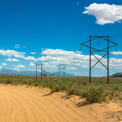 Power lines beside a sand road in Moab Utah