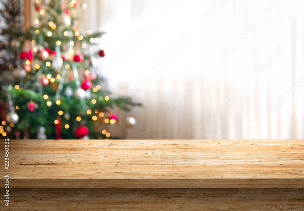 Poster empty wood table top and blur of room with a christmas tree background, suitable for montage product