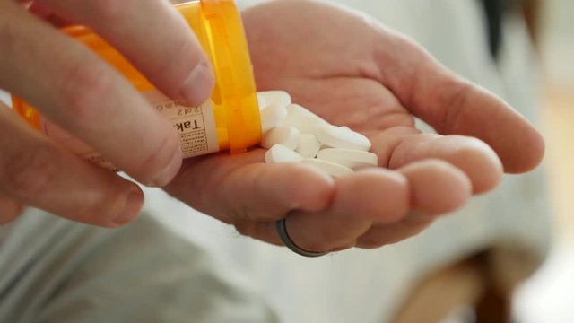 Dolly of man about to overdose on prescription drugs
